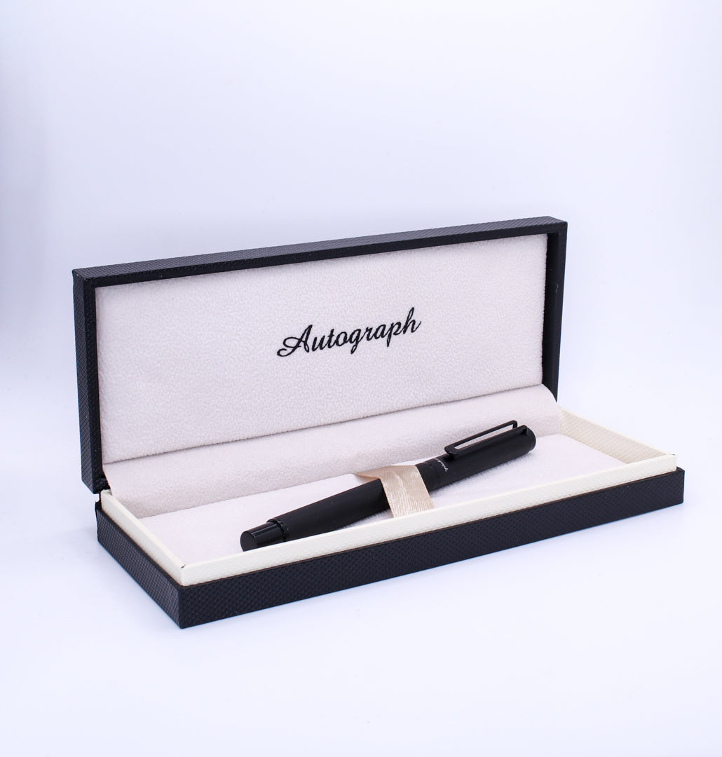 Black pen in an open display box with 'Autograph' branding on a white background