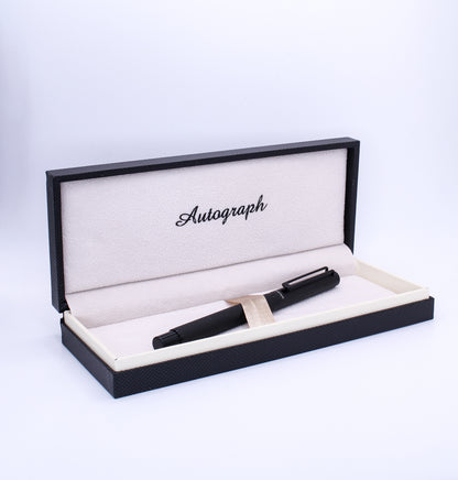 Black pen in an open display box with 'Autograph' branding on a white background
