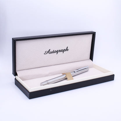 Silver pen in a black and white display box with 'Autograph' text.