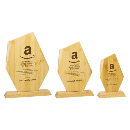 Three wooden awards with Amazon branding on a white background