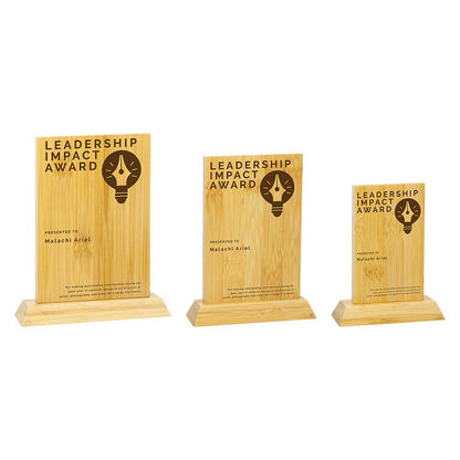 Three wooden 'Leadership Impact Award' plaques on a white background