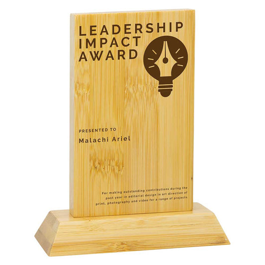 Wooden award with 'Leadership Impact Award' text and a light bulb icon on a white background