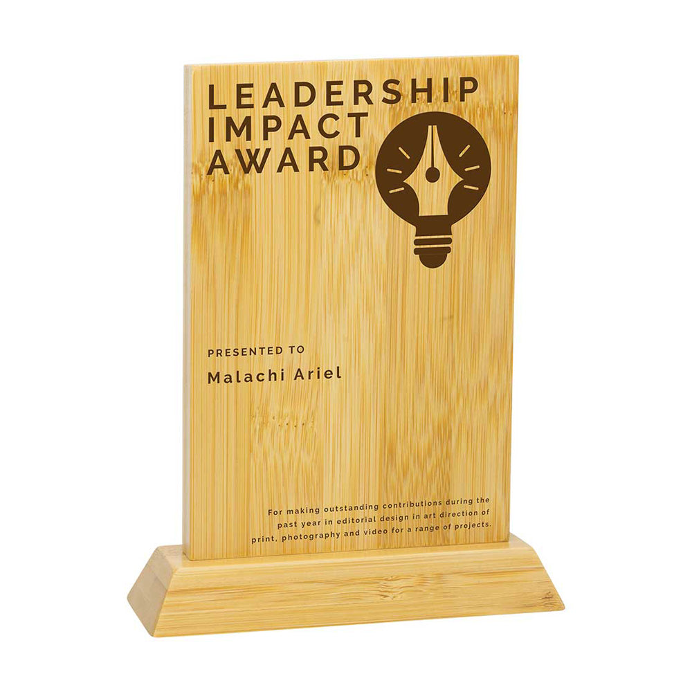 Wooden award plaque with 'Leadership Impact Award' text and a light bulb icon on a white background.