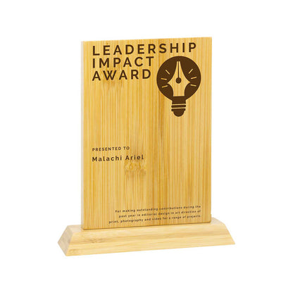 Wooden award plaque with 'Leadership Impact Award' text and a light bulb icon on a white background.