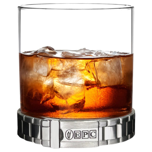 Glass of iced whiskey with a metallic base on a white background