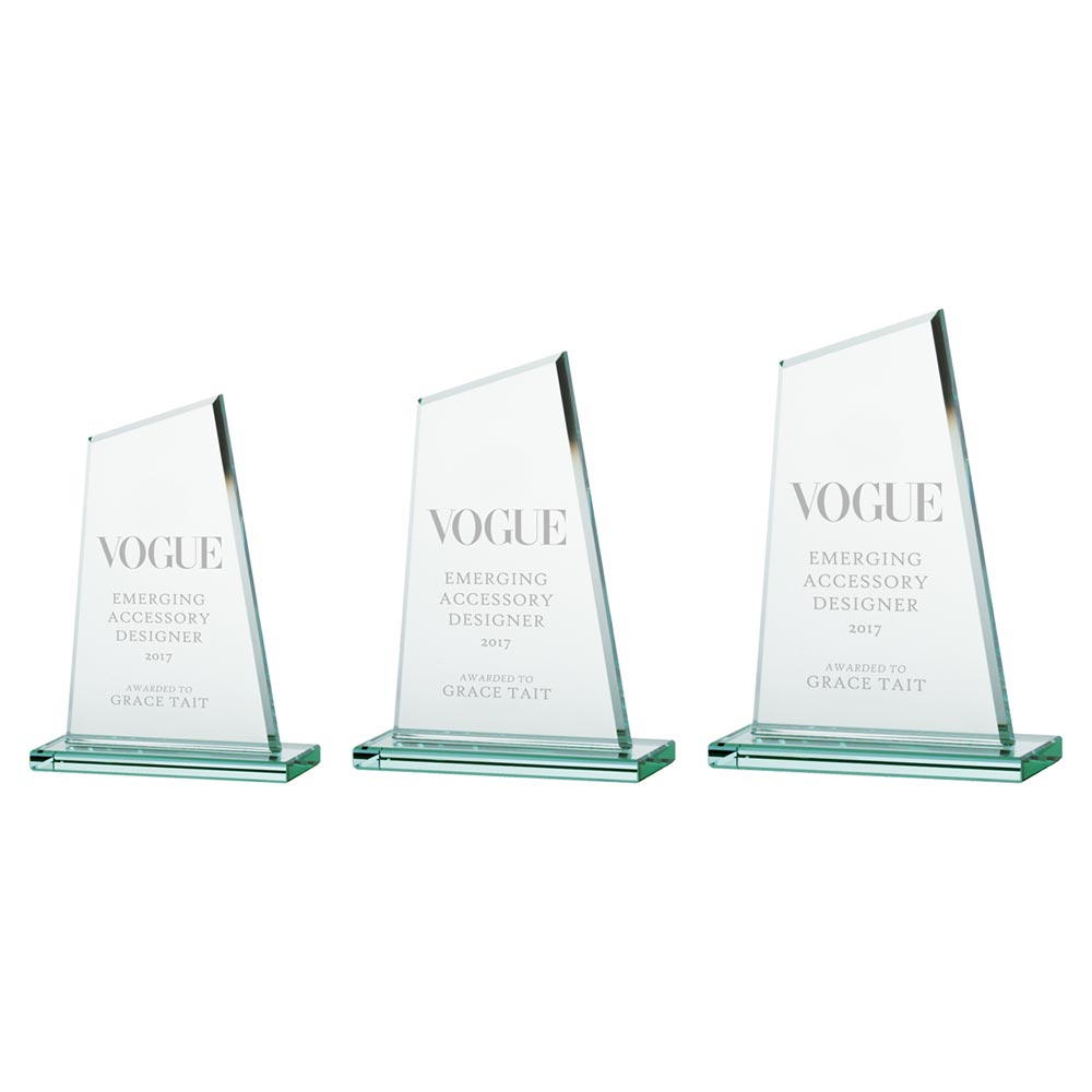 Three glass awards in varying sizes with 'Vogue' text on a white background