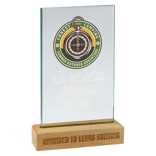 Glass award with wooden base featuring a compass design and text on a white background