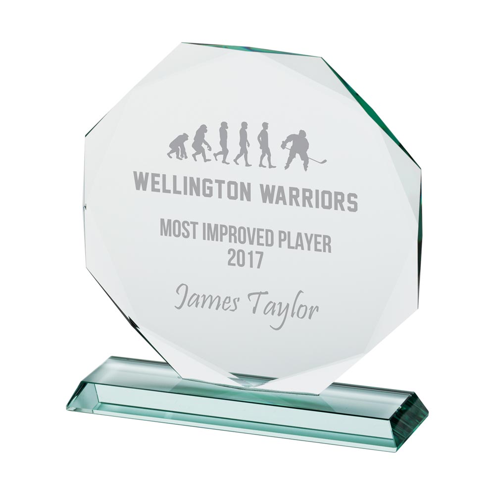 Glass award with engraved text on a white background
