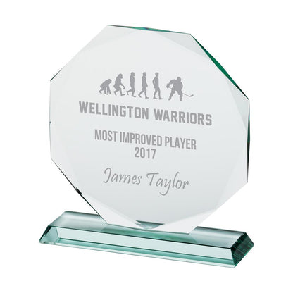 Glass award with engraved text on a white background