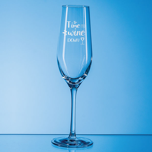 Clear wine glass with 'Time to Swine Down' text on a blue background
