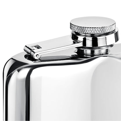 Close-up of a shiny metal flask with a cap on a white background