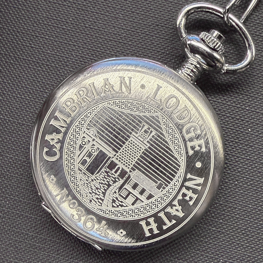 Silver pocket watch with 'Cambrian Lodge Neath' engraving on a dark textured background