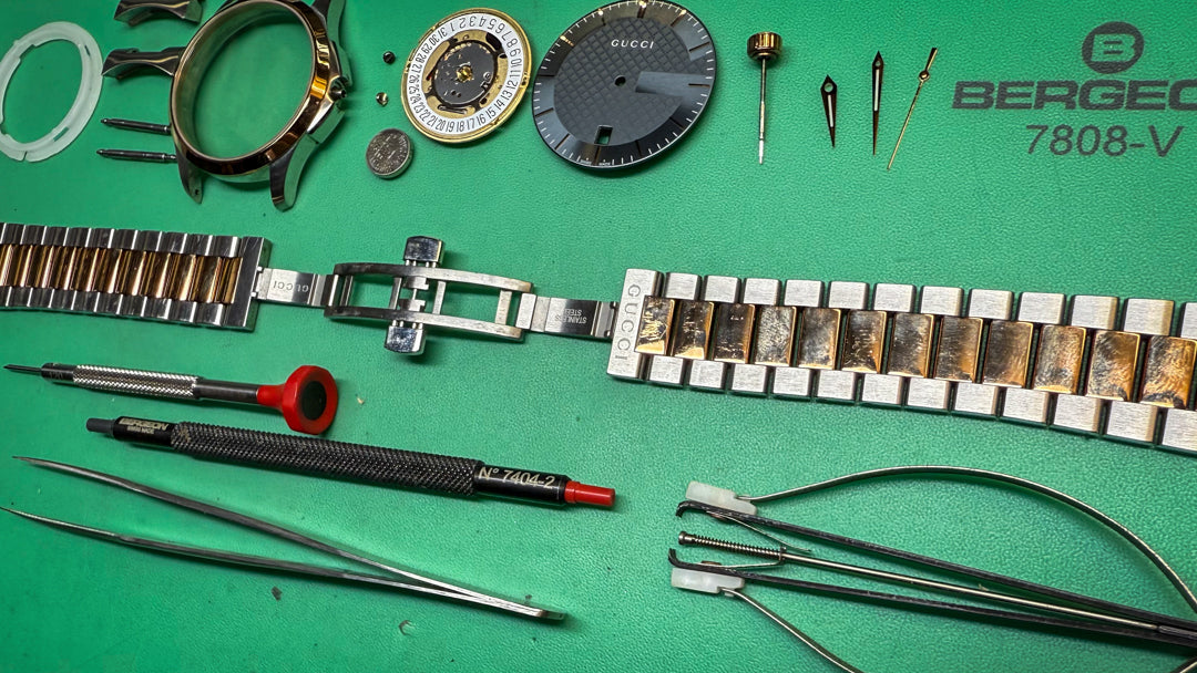 Watch parts and tools on a green surface with Bergeon branding.